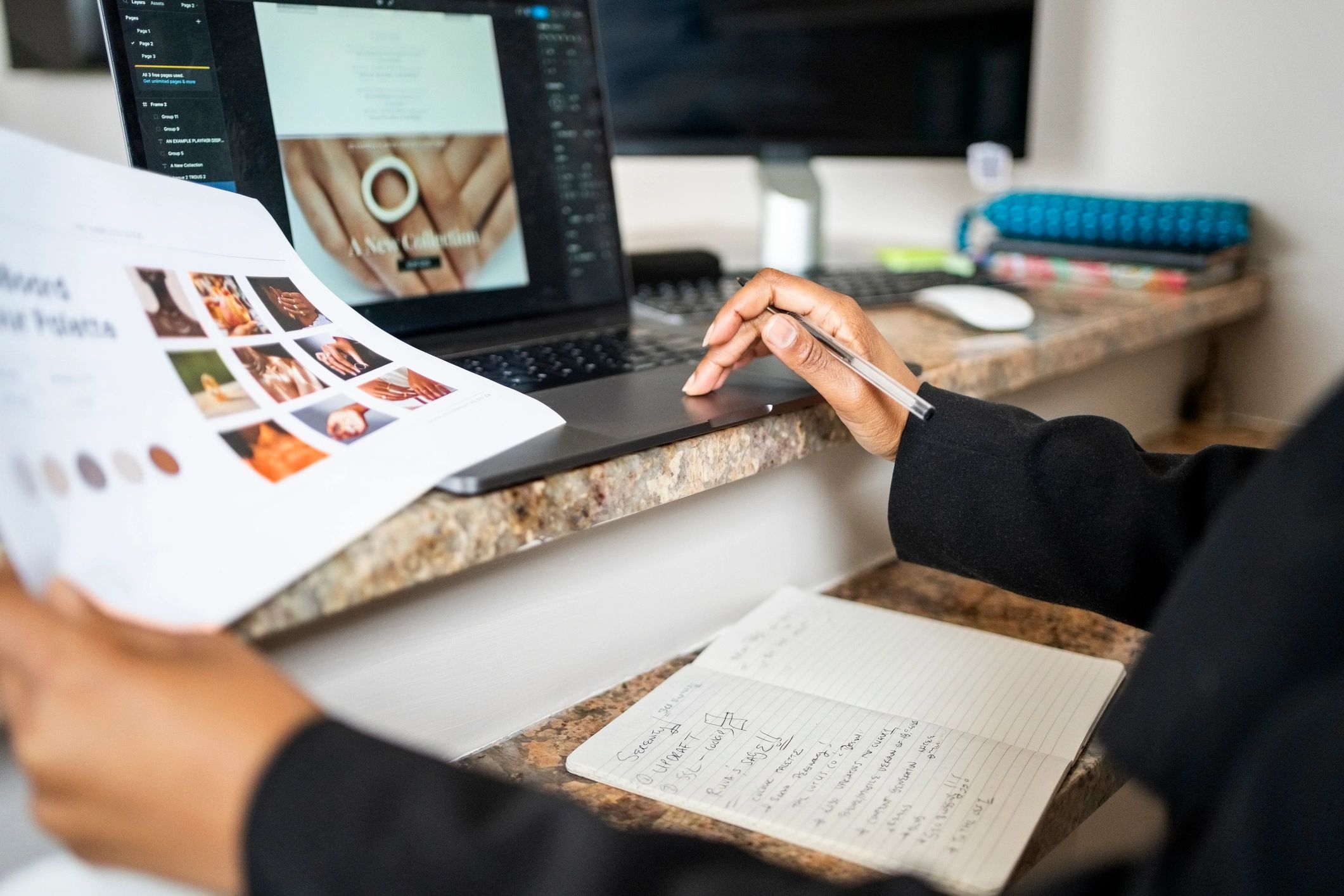 Website designer working on a laptop in a creative office