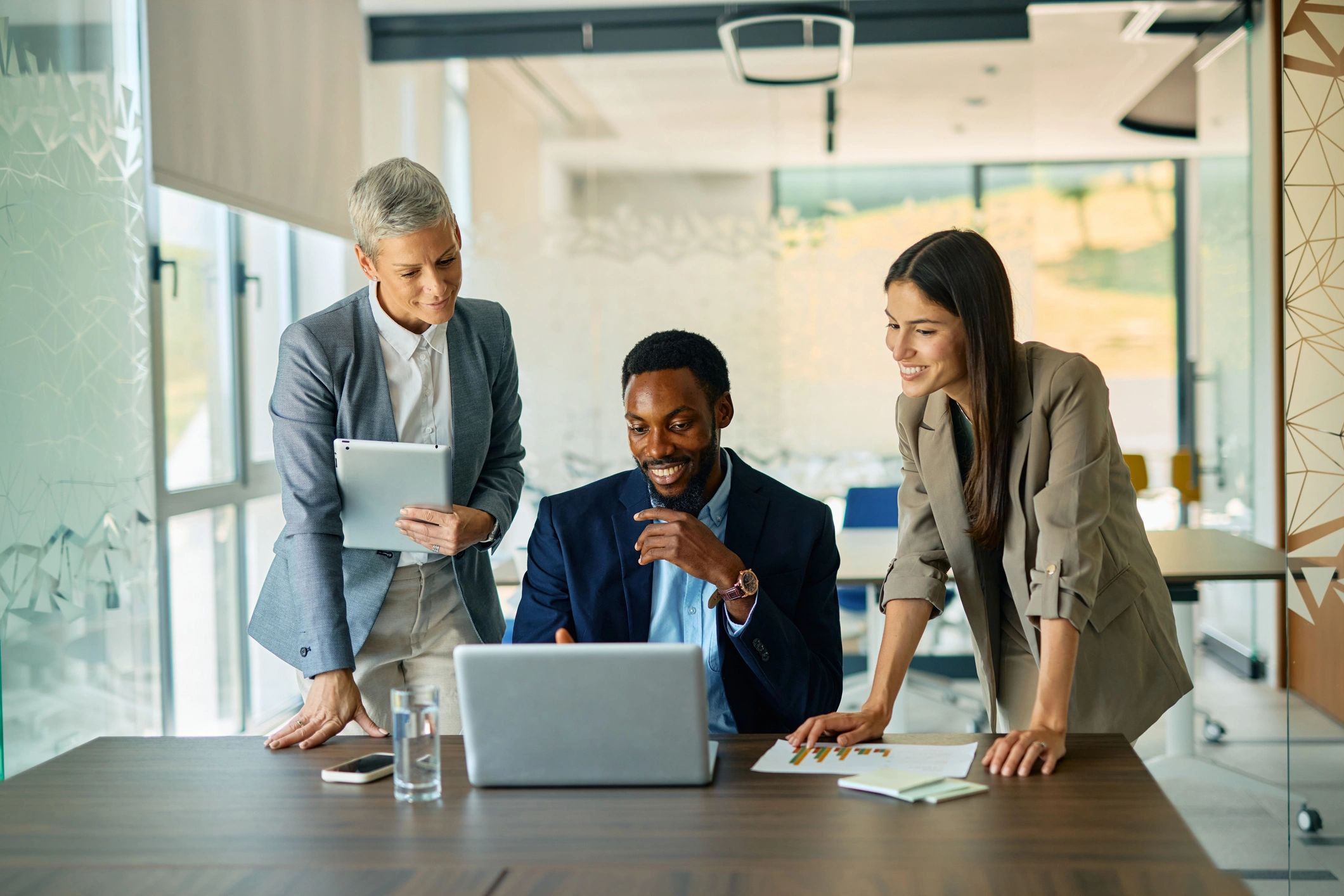AD Media Group team collaborating on a marketing strategy in a modern office